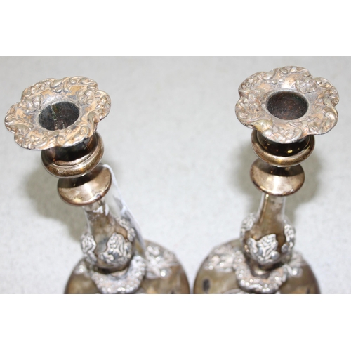 1008 - A pair of antique silver plated candlesticks, seemingly unmarked, each approx 24cm tall