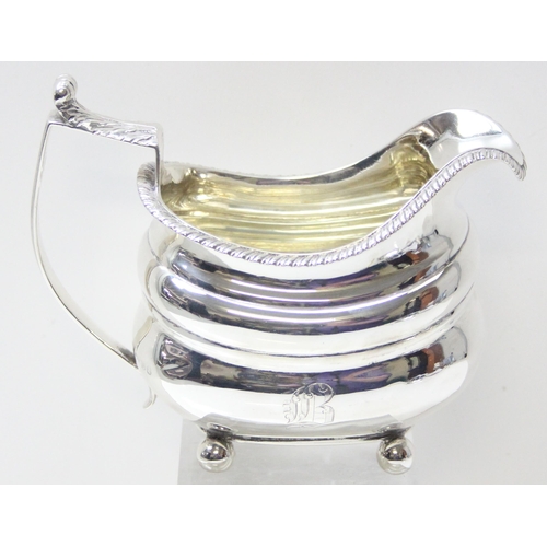 1031 - A George IV period silver helmet shaped cream jug, London 1822 by George Knight, approx 228.52g gros... 