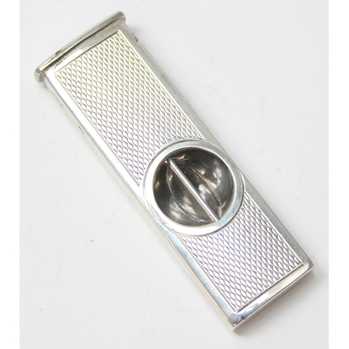 1037 - A vintage silver mounted cigar cutter with engine turned decoration, Birmingham 1973, approx 5cm lon... 