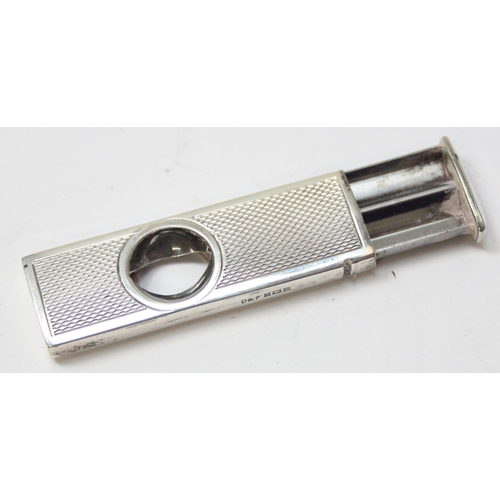 1037 - A vintage silver mounted cigar cutter with engine turned decoration, Birmingham 1973, approx 5cm lon... 