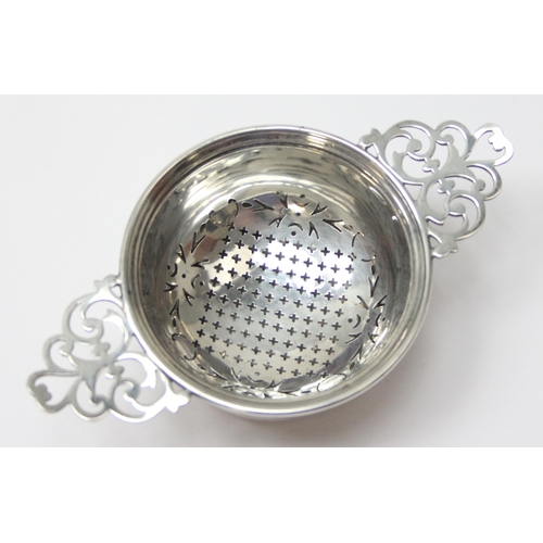 1048 - A vintage silver tea strainer and drip tray, Birmingham 1955 by Adie Brothers, approx 80.31g gross