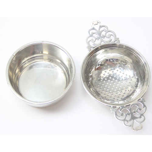 1048 - A vintage silver tea strainer and drip tray, Birmingham 1955 by Adie Brothers, approx 80.31g gross