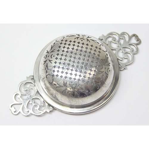 1048 - A vintage silver tea strainer and drip tray, Birmingham 1955 by Adie Brothers, approx 80.31g gross