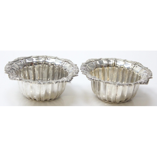 1072 - A pair of impressive heavy cast silver bowl and saucers, marked with Arabic hallmarks, likely of Emi... 