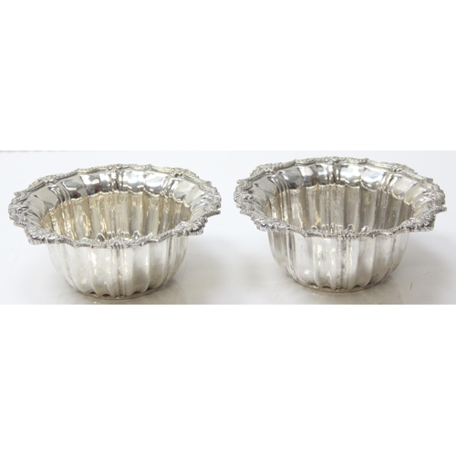 1073 - A pair of impressive heavy cast silver bowl and saucers, marked with Arabic hallmarks, likely of Emi... 