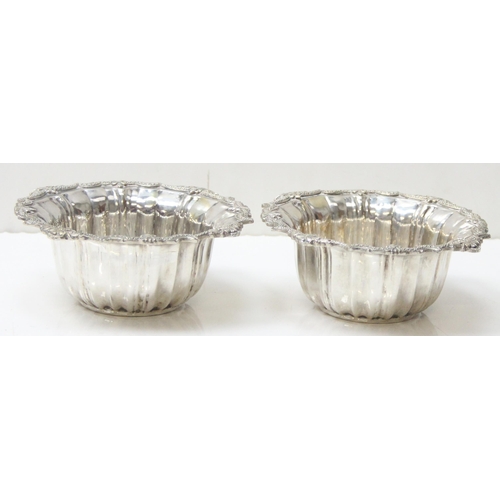 1074 - A pair of impressive heavy cast silver bowl and saucers, marked with Arabic hallmarks, likely of Emi... 