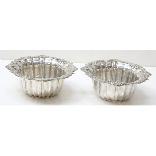 1075 - A pair of impressive heavy cast silver bowl and saucers, marked with Arabic hallmarks, likely of Emi... 