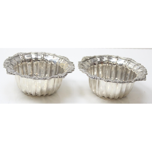 1076 - A pair of impressive heavy cast silver bowl and saucers, marked with Arabic hallmarks, likely of Emi... 