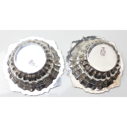 1077 - A pair of impressive heavy cast silver bowl and saucers, marked with Arabic hallmarks, likely of Emi... 