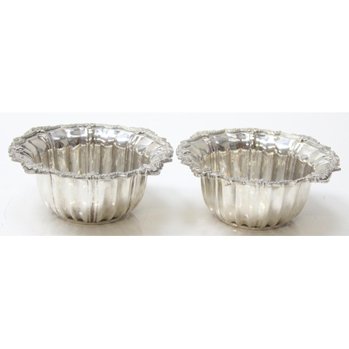 1077 - A pair of impressive heavy cast silver bowl and saucers, marked with Arabic hallmarks, likely of Emi... 