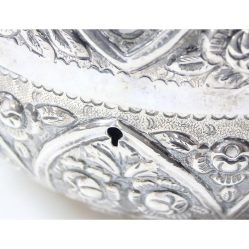 1078 - A large silver pumpkin shaped keepsake box, the exterior decorated with repousse flowers, the hinged... 