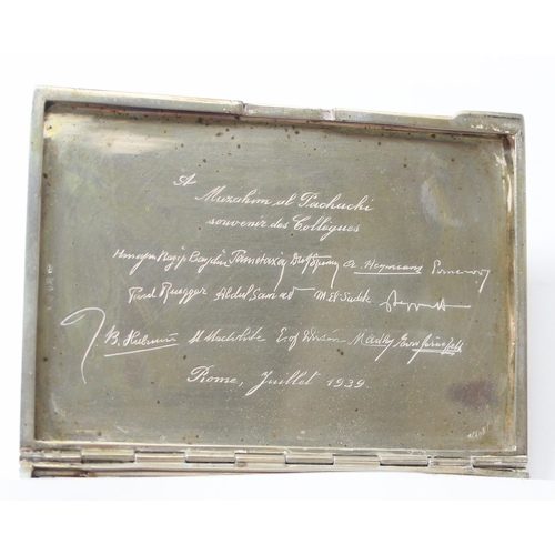 1091 - An Italian 800 silver cigarette case with striped decoration, dedication inside to Adnan Muzahim Ame... 