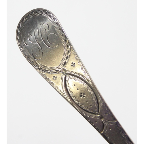 1097 - A George III period silver serving spoon with bright cut decoration, London 1797 by Thomas Streetin,... 