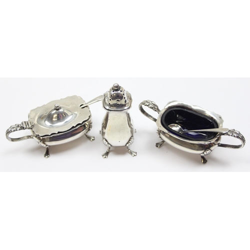 1099B - A silver 3 piece cruet set, Birmingham 1912 by Davis, Moss & Co with 2 associated silver spoons, app... 