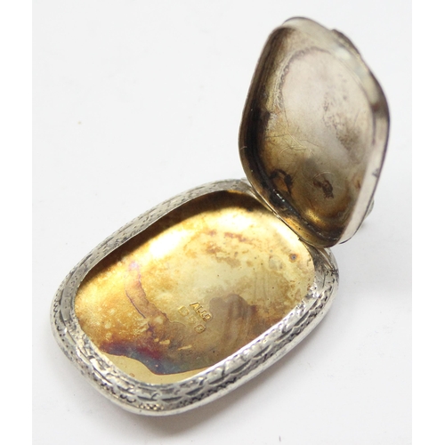 1099O - A silver pill box with engraved floral decoration and gilt interior, Chester 1918 by Adie & Lovekin