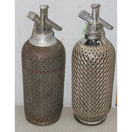 1786 - 2 Art Deco period soda siphon seltzer bottles with wire-mesh covering