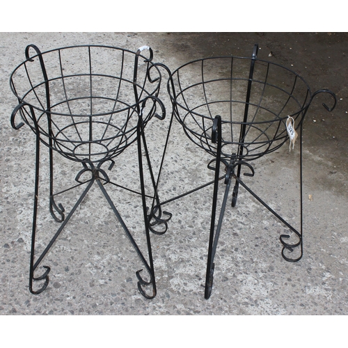 323 - A pair of wrought iron garden basket planters and faux bushes, each approx 58cm tall x 40cm wide