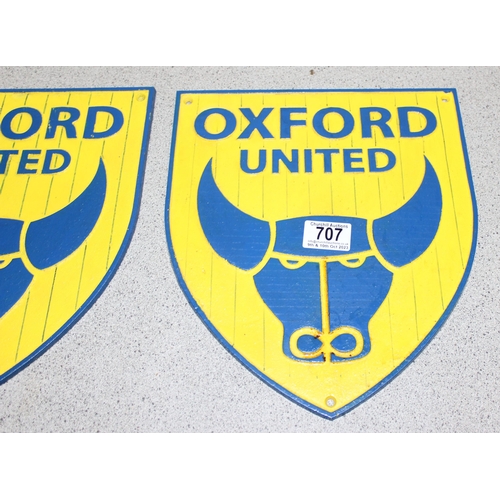 707 - Two cast iron Oxford United shield shaped wall plaques, approx 30cm x 27cm