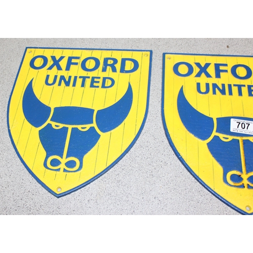 707 - Two cast iron Oxford United shield shaped wall plaques, approx 30cm x 27cm