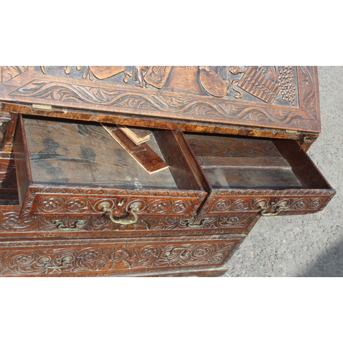 98 - An impressive profusely carved oak bureau, likely Georgian with later carving of a theatrical nature... 