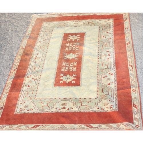 216A - A vintage Turkish wool rug of red and cream ground, approx 313cm x 211cm