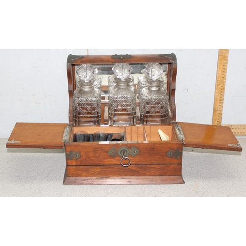 283 - Antique oak tantalus with brass fittings with 3 matching cut glass decanters and shot glasses approx... 