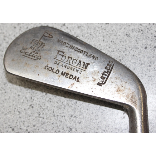 704 - Qty of vintage wooden handled and other golf clubs to include various irons and putters