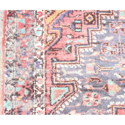 219A - Roll of colourful upholstery material, approx 150cm wide, and woollen hand tied red ground rug appro... 