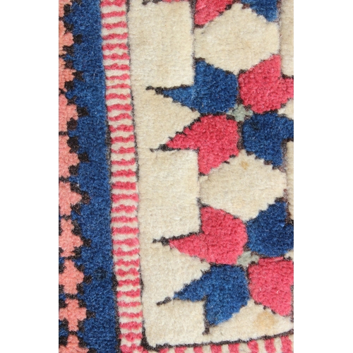 209 - A hand knotted vintage red, blue and cream ground Kazak rug, approx 144cm x 115cm