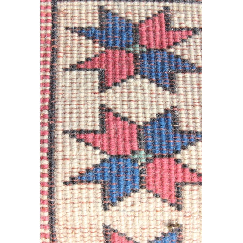 209 - A hand knotted vintage red, blue and cream ground Kazak rug, approx 144cm x 115cm