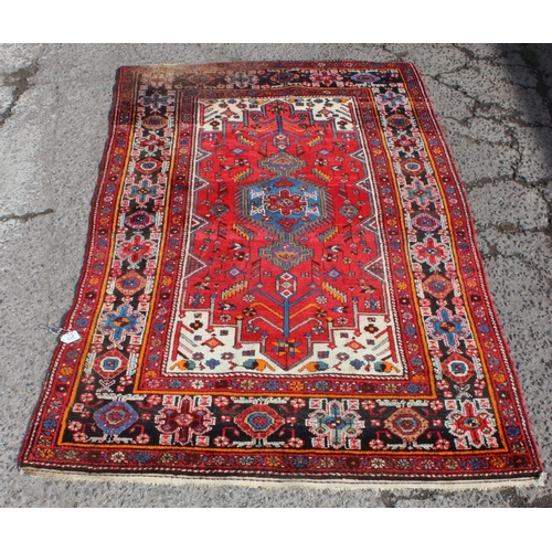 211 - A vintage red ground handmade rug with colourful decoration, possibly Hamadan region, approx 230cm x... 