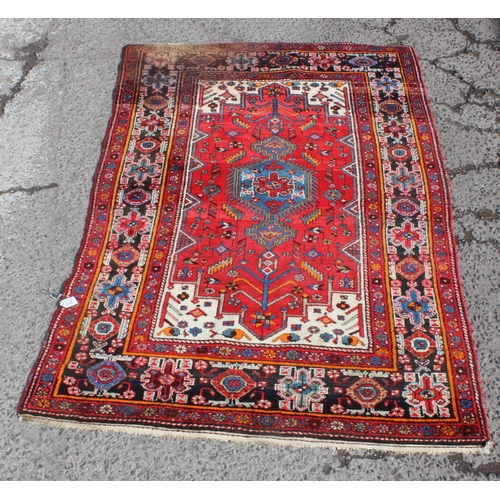 211 - A vintage red ground handmade rug with colourful decoration, possibly Hamadan region, approx 230cm x... 