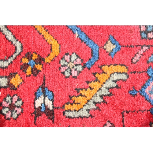 211 - A vintage red ground handmade rug with colourful decoration, possibly Hamadan region, approx 230cm x... 