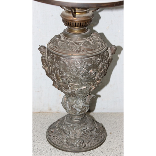 269A - An antique oil lamp, the base cast spelter depicting scenes of either missionaries or slave traders ... 