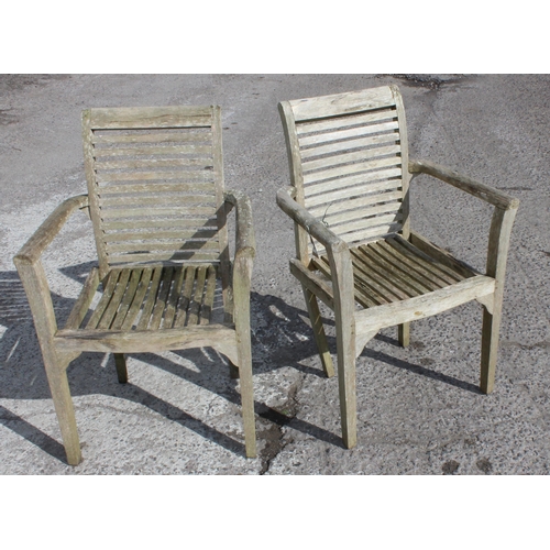 330 - A pair of weathered teak garden chairs