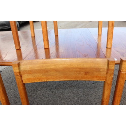 106 - A retro Nissen of Denmark extending dining table and 6 chairs, approx 247cm wide x 108cm deep x 73cm... 