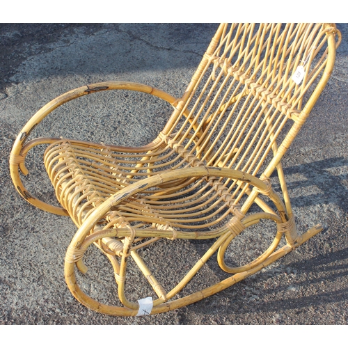 128 - A retro bamboo and wicker rocking chair, strongly in the manner of Franco Albini, approx 56cm wide x... 