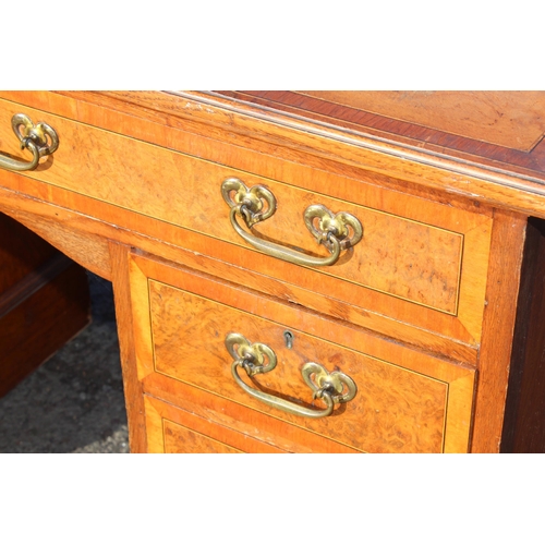 129 - A vintage burrwood and crossbanded 8 drawer desk, approx 122cm wide x 56cm deep x 77cm tall