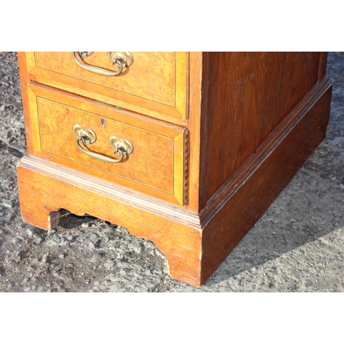 129 - A vintage burrwood and crossbanded 8 drawer desk, approx 122cm wide x 56cm deep x 77cm tall