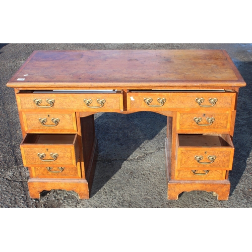 129 - A vintage burrwood and crossbanded 8 drawer desk, approx 122cm wide x 56cm deep x 77cm tall