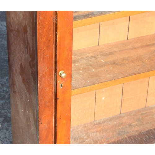 130 - An antique mahogany bookcase with glazed door, approx 105cm wide x 34cm deep x 107cm tall