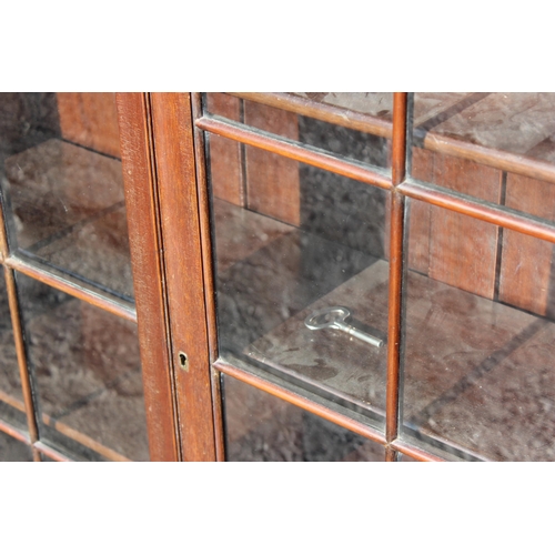 131 - An early 20th century mahogany bookcase with glazed doors, approx 93cm wide x 28cm deep x 123cm tall