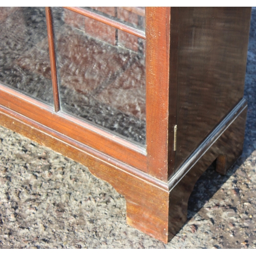 131 - An early 20th century mahogany bookcase with glazed doors, approx 93cm wide x 28cm deep x 123cm tall