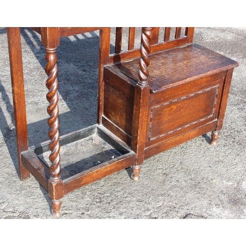 133 - An early 20th century oak hall stand with stick stand and storage seat, approx 97cm wide x 31cm deep... 