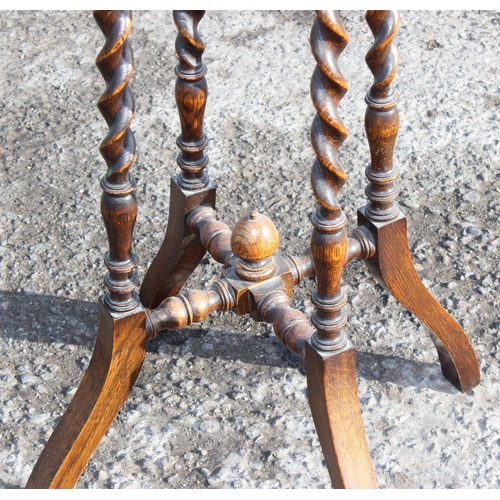 134 - An early 20th century oak jardiniere stand with barleytwist supports, approx 35cm in diameter x 105c... 