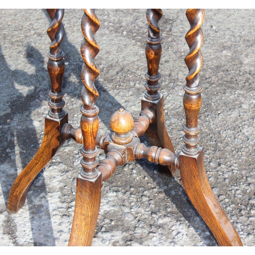 134 - An early 20th century oak jardiniere stand with barleytwist supports, approx 35cm in diameter x 105c... 