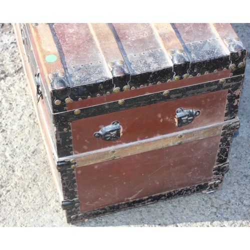 136 - An early 20th century antique iron and wooden banded shipping trunk with flat top, approx 81cm wide ... 