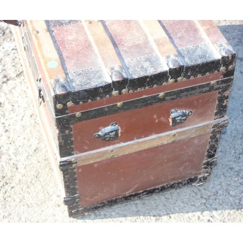 136 - An early 20th century antique iron and wooden banded shipping trunk with flat top, approx 81cm wide ... 