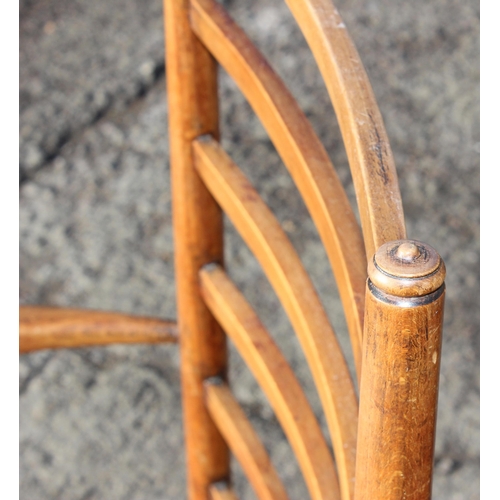 137 - In the manner of Liberty of London, an Arts & Crafts period oak ladder back armchair with rush seat