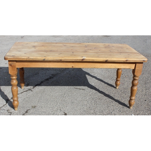 145 - A large pine farmhouse kitchen table, approx 180cm wide x 92cm deep x 78cm tall